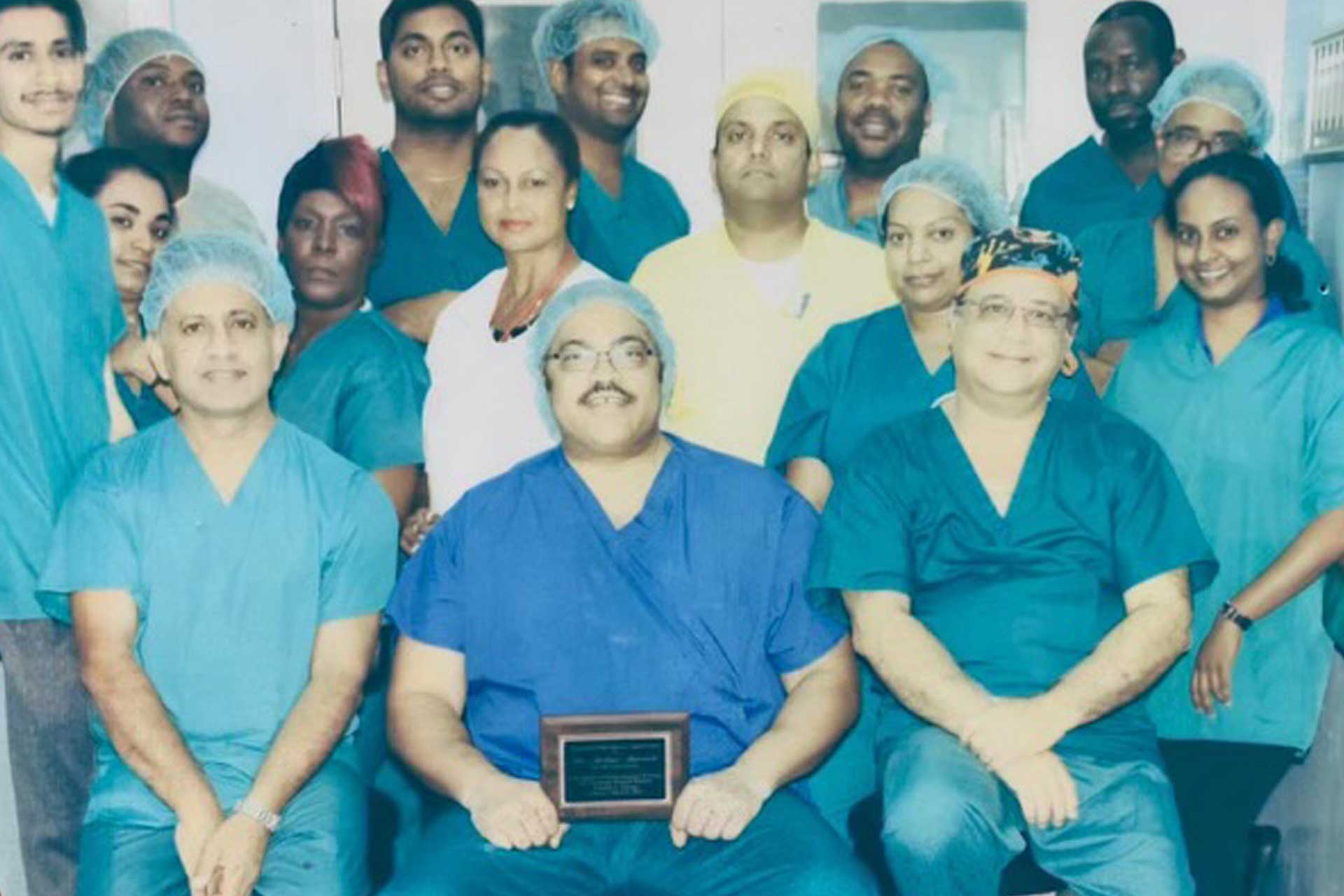 Group of healthcare professionals posing together in medical uniforms