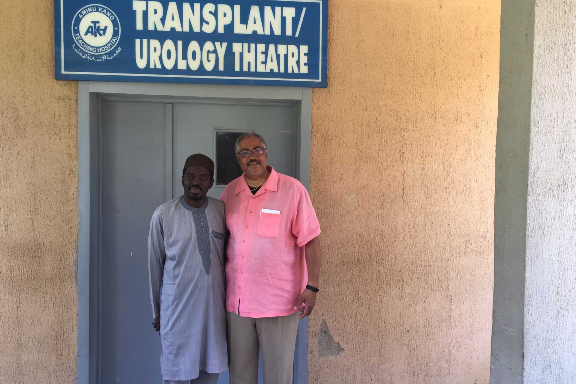 Two people standing at an office entrance during a visit or meeting