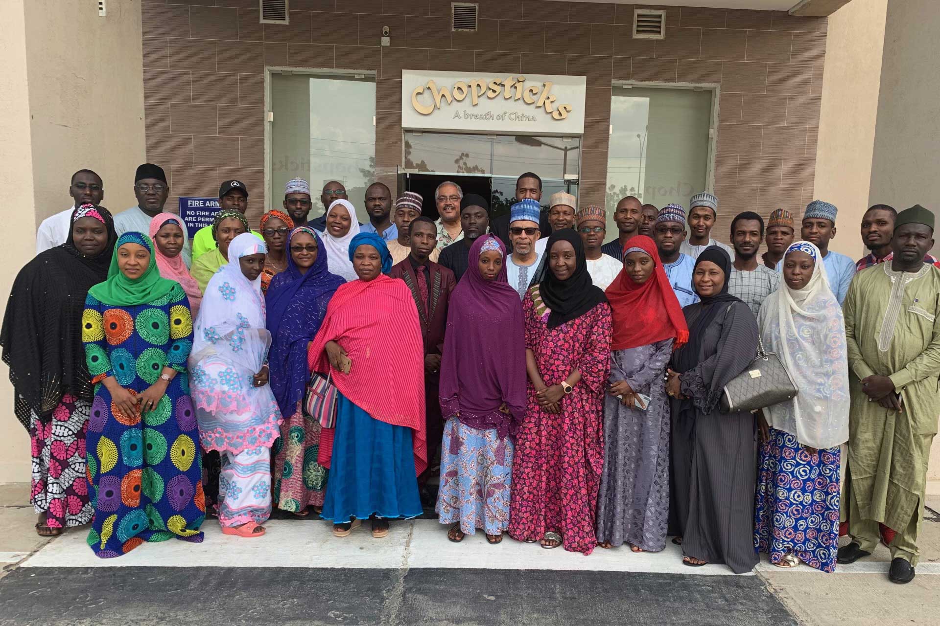Community group posing together for a group photo indoors