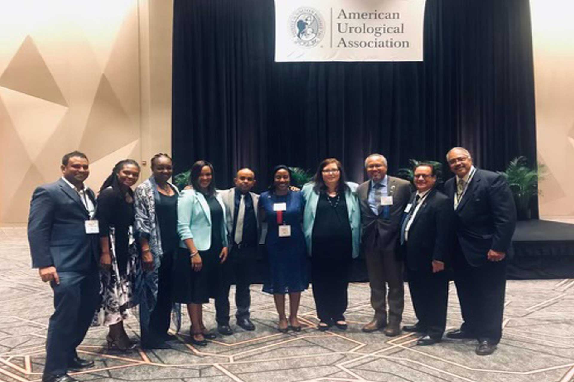 Formal team group photo of professionals standing in a conference setting