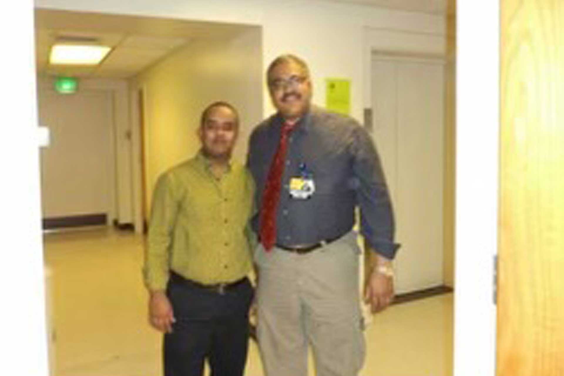 Two individuals greeting each other during an official visit